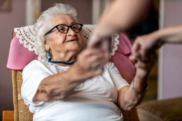 Older woman receives assistance from caregiver - funeral service