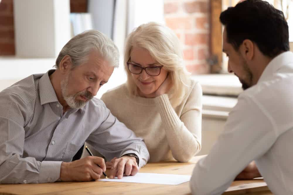 Couple signs document - what is cremation preplanning?