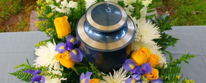 A cremation urn surrounded by flowers