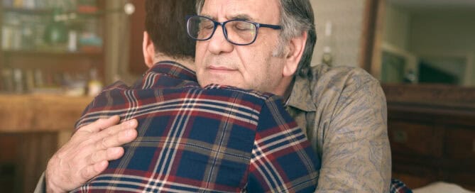 Father and son hugging.