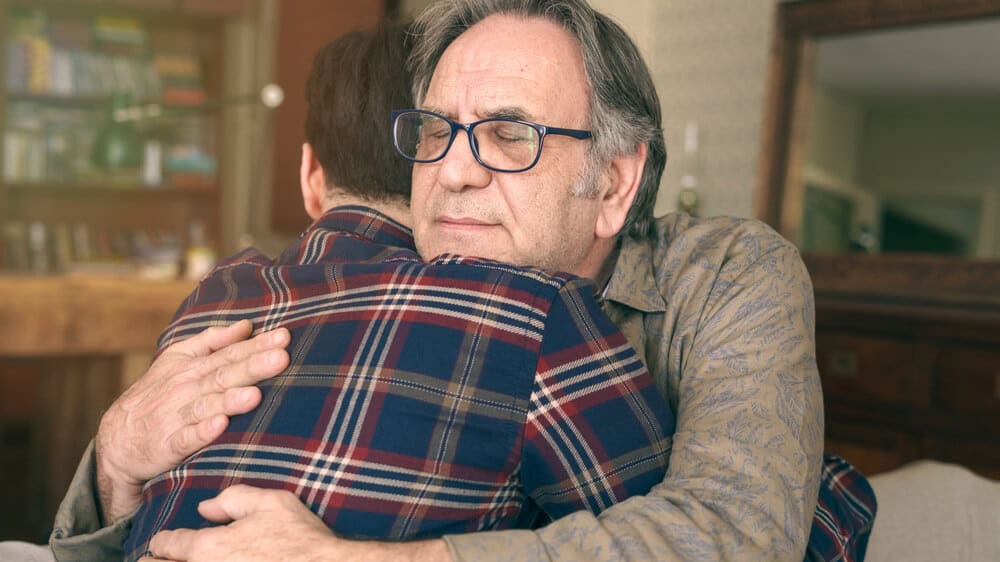 Father and son hugging.