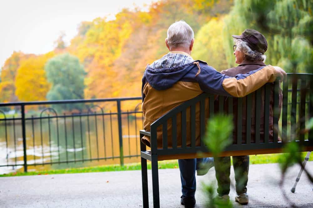 older couple share a park bench