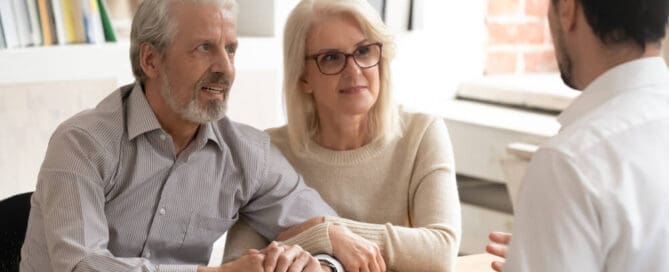 Funeral director discusses different funeral home cremation packages with an older couple.