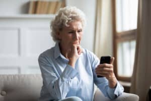 older woman reading obituaries