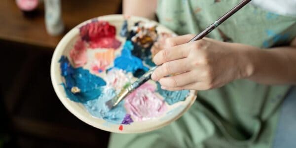 A portrait artist mixes colors to develop a memorial piece for a family missing a loved one.